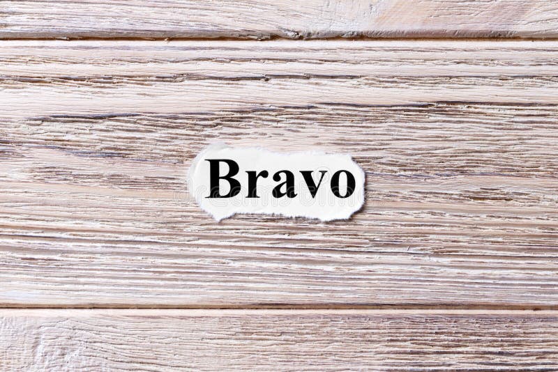 BRAVO of the word on paper. concept. Words of BRAVO on a wooden background. BRAVO of the word on paper. concept. Words of BRAVO on a wooden background.