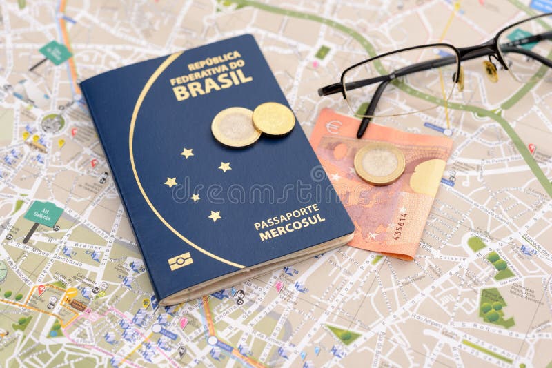 Brazilian passport, euros, glasses and map for travel abroad. Passport, euros, glasses and map for travel abroad. Brazilian passport and map of the city of royalty free stock images Brazilian passport, euros, glasses and map for travel abroad. Passport, euros, glasses and map for travel abroad. Brazilian passport and map of the city of royalty free stock images