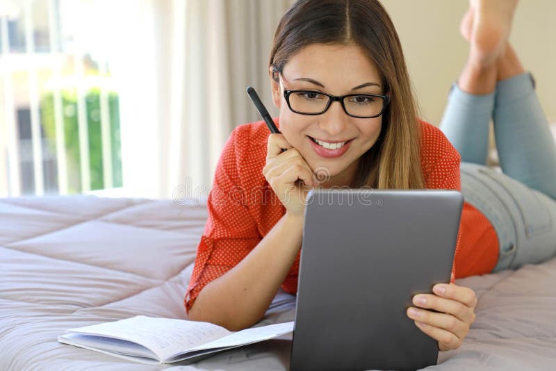 Brazilian young business woman wearing glasses video calling chat distance webinar online on tablet by webcam or attends online stock image Brazilian young business woman wearing glasses video calling chat distance webinar online on tablet by webcam or attends online stock image