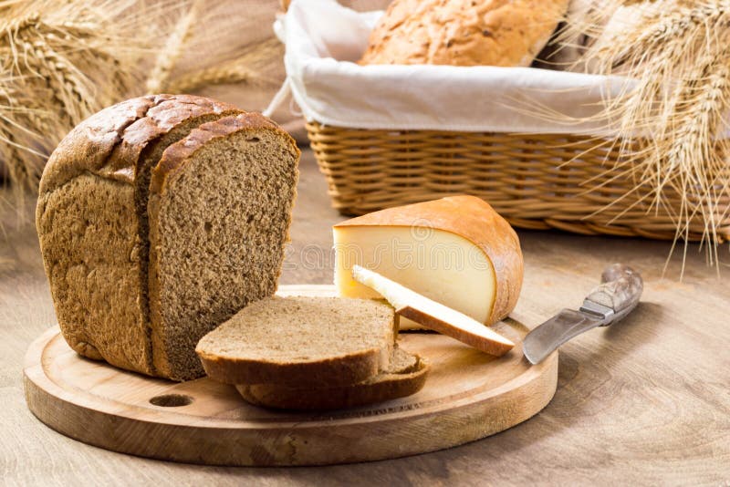 Few Loaves Ears On The Board Bread And Cheese Sliced For Sandwiches Amid The Loaves In