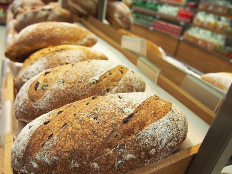 Bread and Buns in on Shelf in Bakery or Baker`s Shop Stock Photo