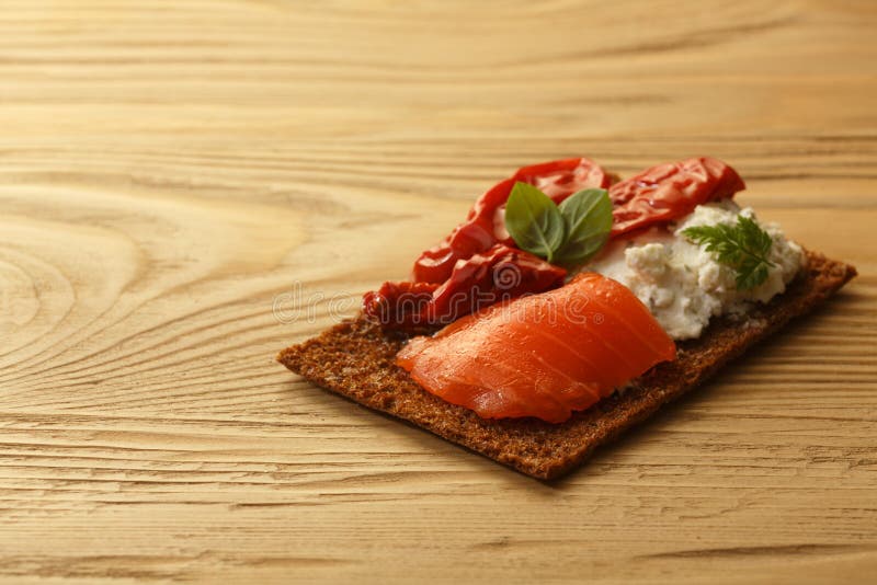 Bread crisp with salmon, soft cheese, dried tomatoes and chervil royalty free stock photo Bread crisp with salmon, soft cheese, dried tomatoes and chervil royalty free stock photo