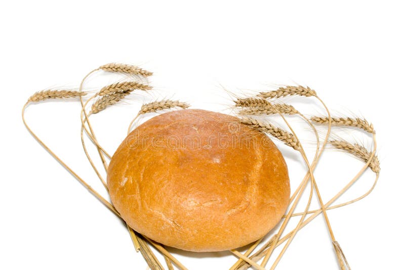 Bread loaf surrounded by wheat spikes, isolated