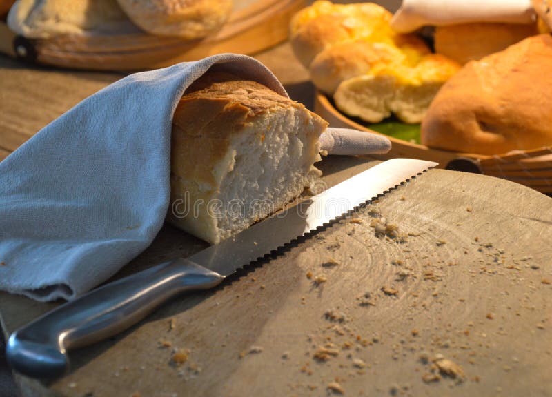 Freshly cut bread with knife stock images Freshly cut bread with knife stock images