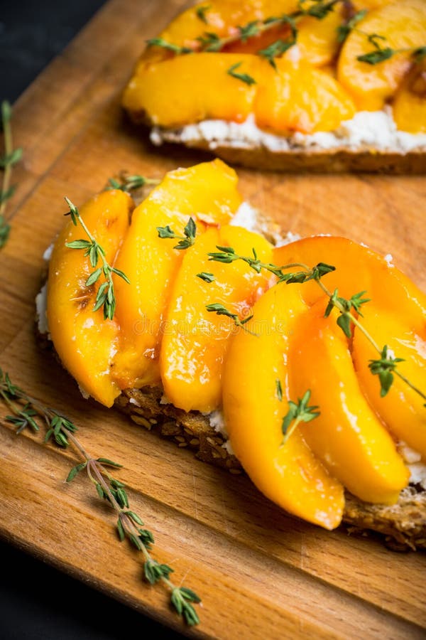 Bread with Ricotta Cheese and Grilled Peaches on the Rustic Background