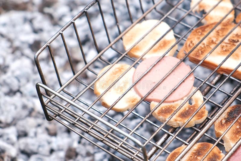Bread and Sausage Fried on Charcoal in the Grill. Stock Photo Image