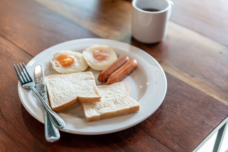 Bread, Sausage and Fried Egg with Black Coffee for Breakfast Stock