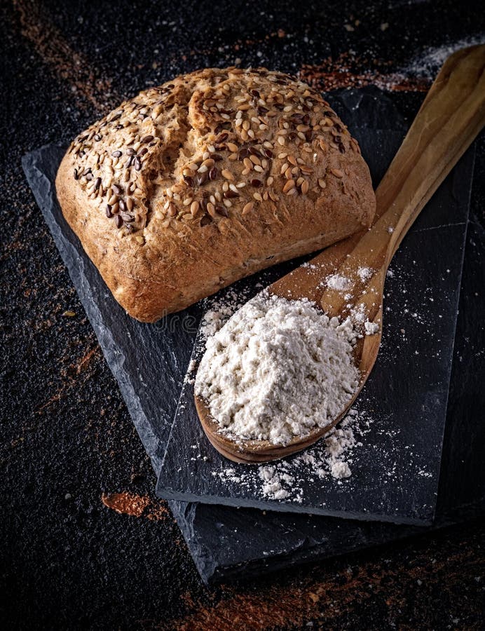 Bread with seeds on bottom with rag and wicker basket. Composition with bread and Wicker Basket. Kitchen view from above. Bread