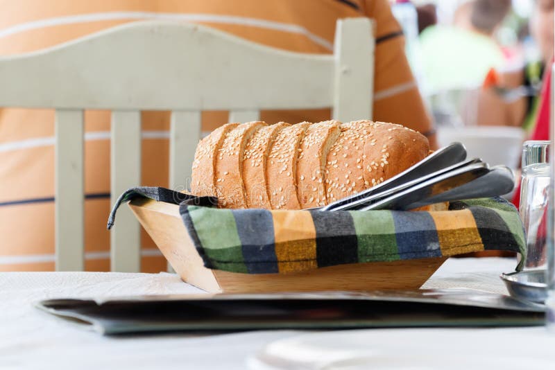 Bread sliced on a basket at a Greek restaurant.