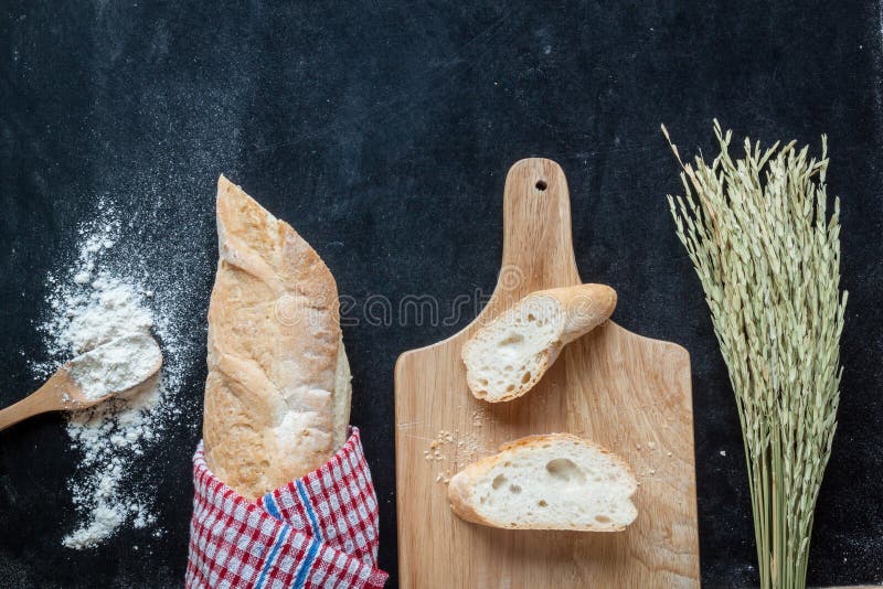 Bread , Wheat and Flour on Black Chalkboard Bakery Background Stock