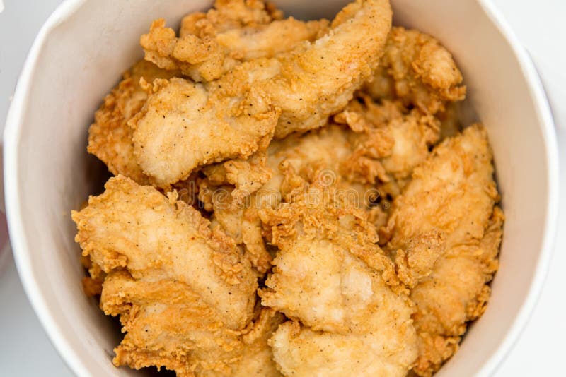 Breaded Chicken Fillet in Bucket. Fried Chicken Strips with Take a Way