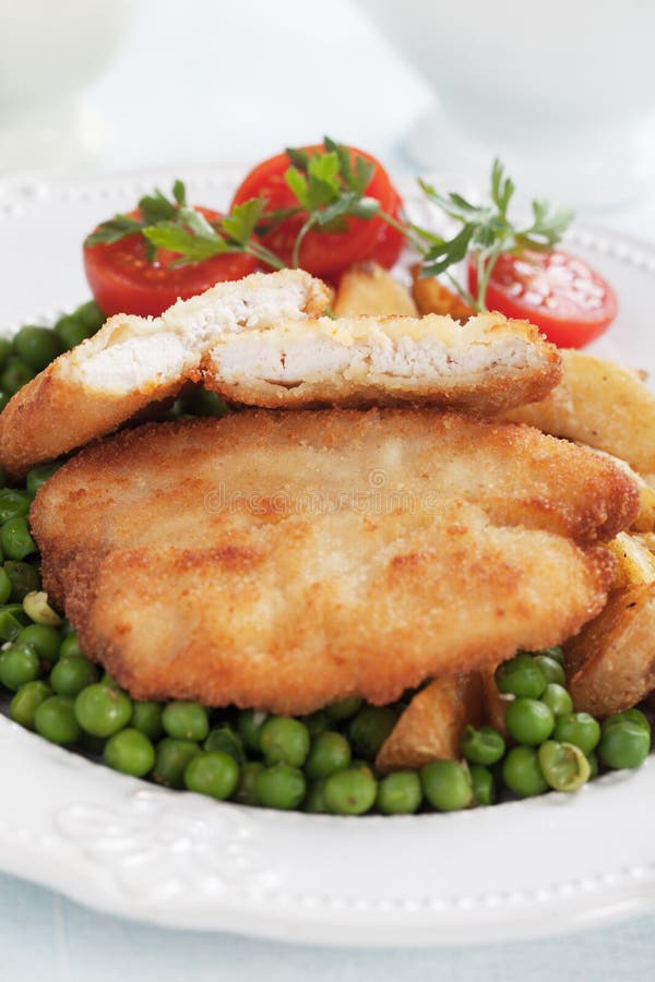 Breaded chicken steak stock photo. Image of breast, peas 97255078