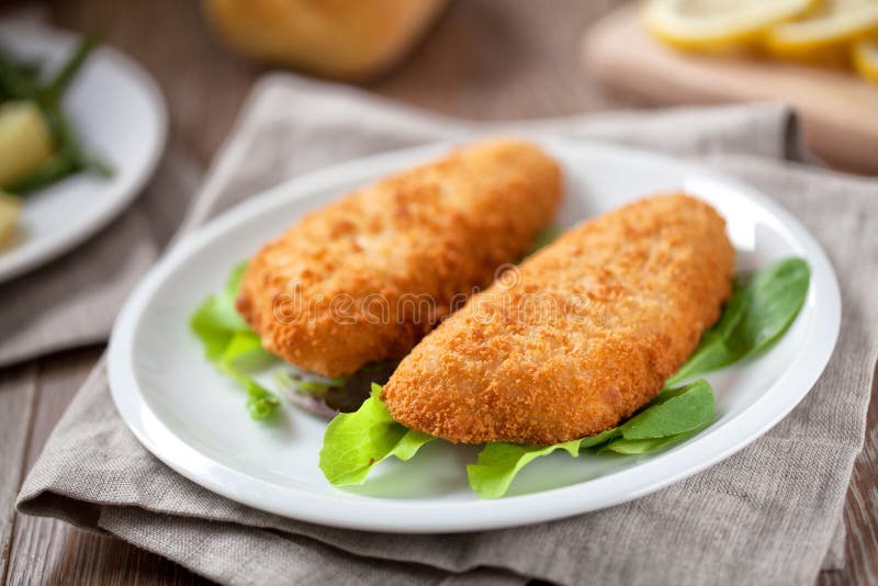 Breaded Fish Fillet With Salad. High quality photo. stock photography