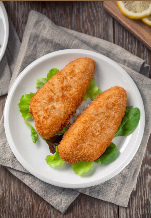 Breaded Fish Fillet With Salad. High quality photo. stock photography