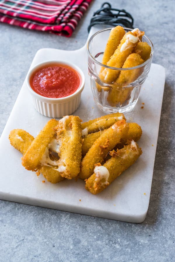 Breaded Fried Mozzarella Cheese Sticks with Ketchup Dipping Sauce Stock