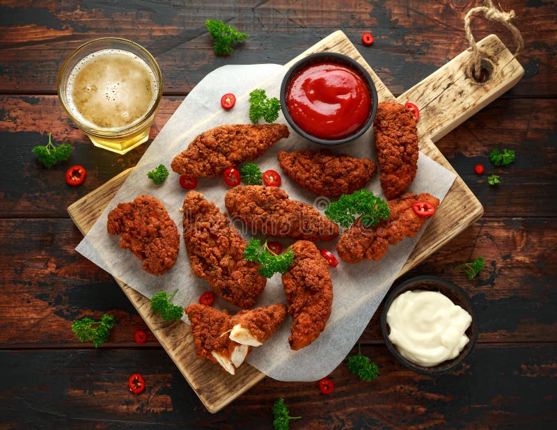 Breaded kurczak obdziera z piwem, ketchupem i majonezem na drewnianej desce, zdjęcia stock Breaded kurczak obdziera z piwem, ketchupem i majonezem na drewnianej desce, zdjęcia stock