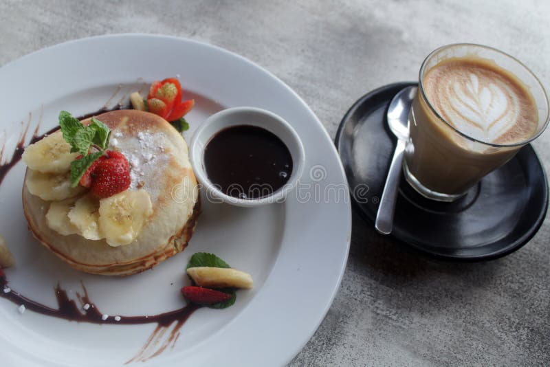 Breakfast with Banana Pancake and Morning Coffee Latte. Good Breakfast