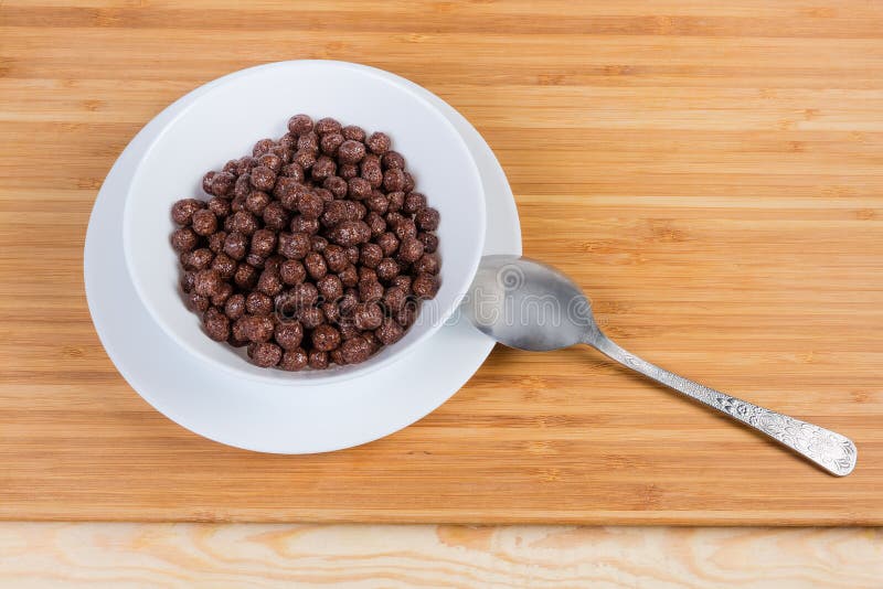 Breakfast Cereal Chocolate Balls in Bowl on a Wooden Surface Stock
