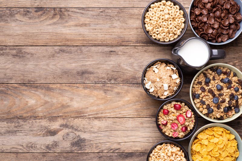 Breakfast cereals in bowls on rustic wooden table, top view stock photo Breakfast cereals in bowls on rustic wooden table, top view stock photo