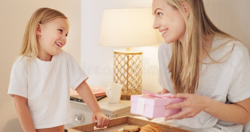 Breakfast, child and mama with a gift on mothers day in the morning to celebrate her mommy at home. Smile, Love and