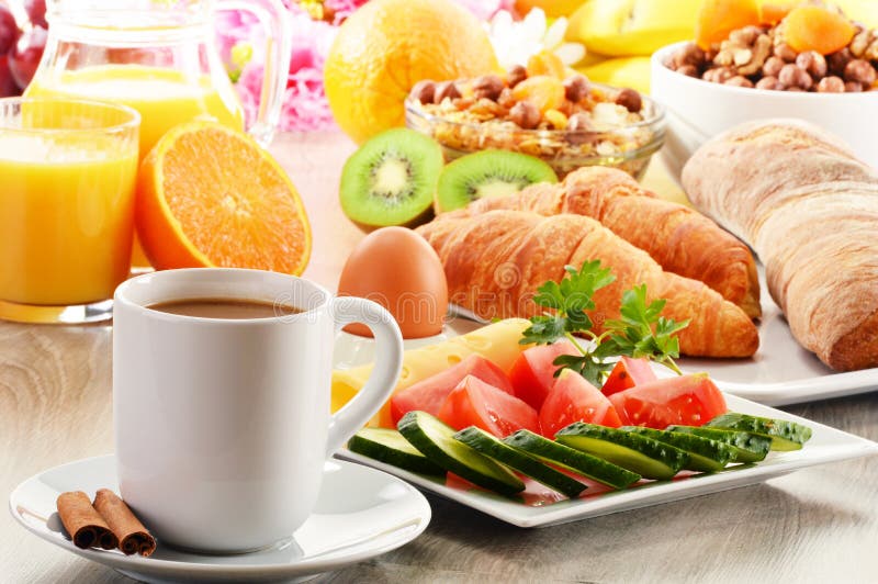 Breakfast with coffee, orange juice, croissant, egg, vegetables