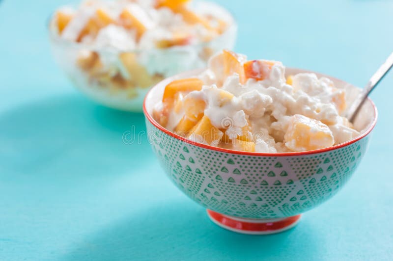 Breakfast Cottage Cheese with Peach Sour Cream and Honey Stock Photo