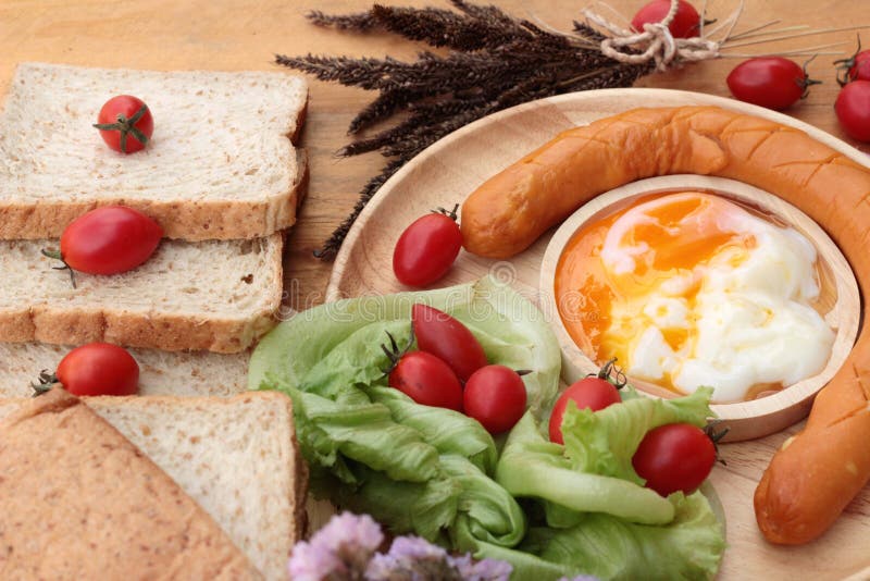 Breakfast with Eggs, Sausage, Bread, Salad Vegetables and Milk. Stock