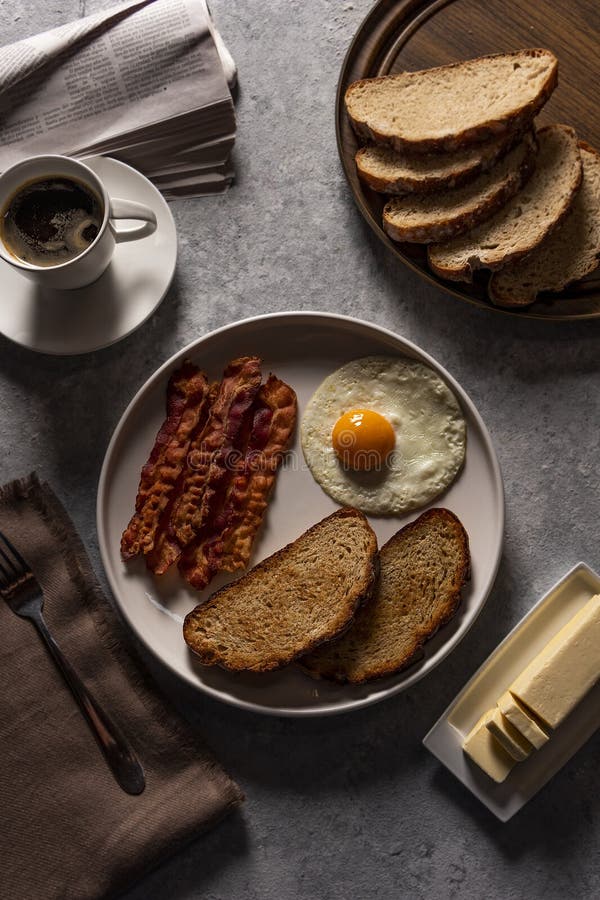 Breakfast with Fried Bacon and Eggs, Toast, and Coffee in Rustic ...