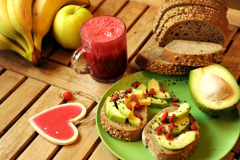 Breakfast with fruit juice and avocado sandwich stock photos Breakfast with fruit juice and avocado sandwich stock photos