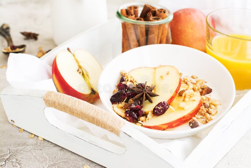 Breakfast with granola, dry cranberry, apple slices