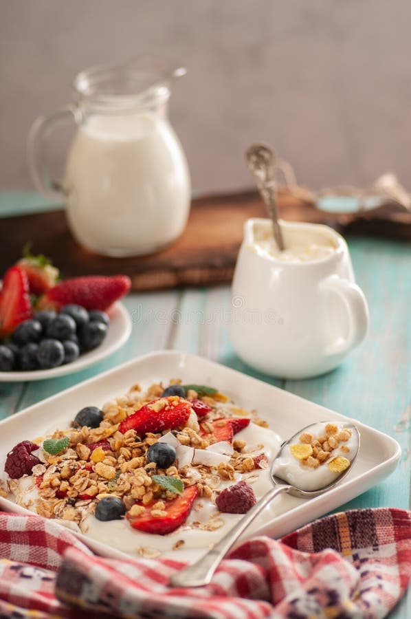 Breakfast granola yogurt, strawberry, blueberries, raspberries on a white plate. stock photo Breakfast granola yogurt, strawberry, blueberries, raspberries on a white plate. stock photo