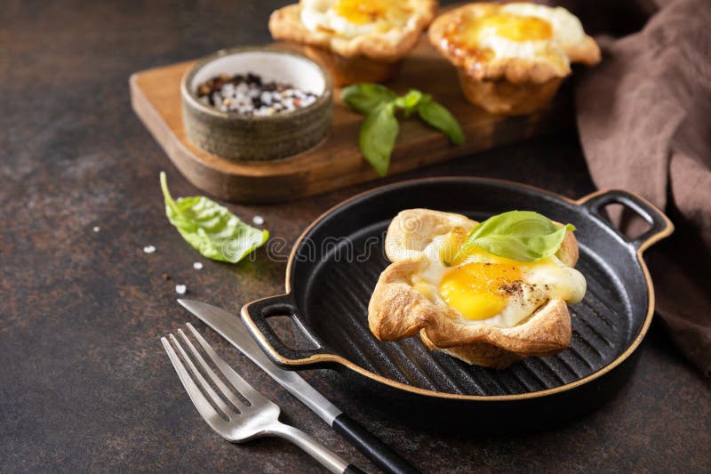 Breakfast Idea. Scrambled Eggs in Puff Pastry with Cheese and Bacon on