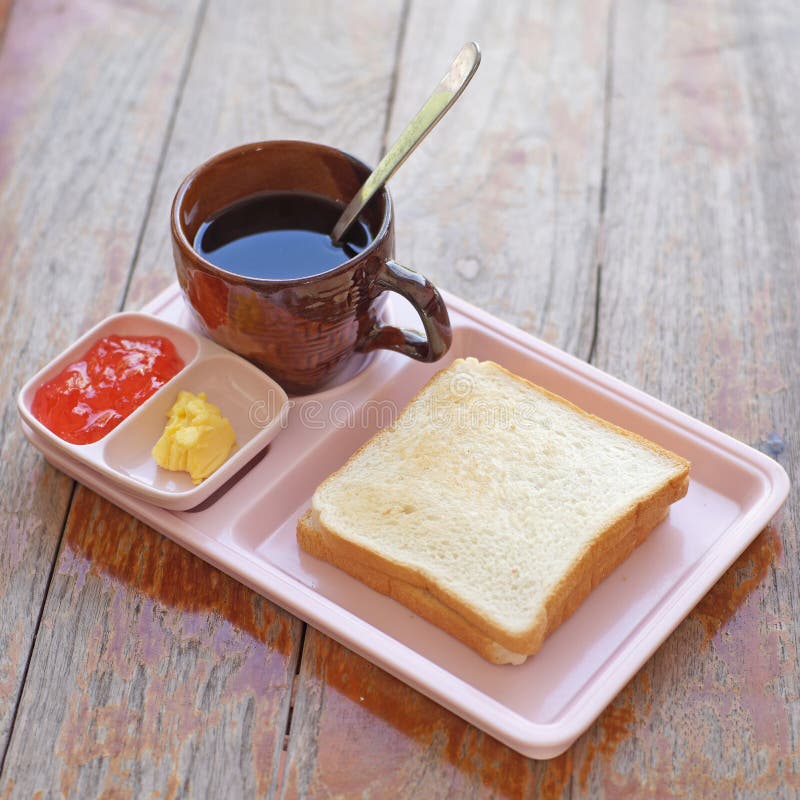 Breakfast meal with coffee slice toast and strawberry jam