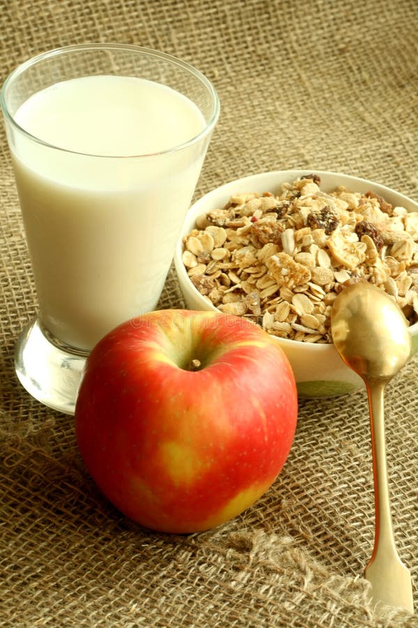 Breakfast, muesli apple and glass of milk