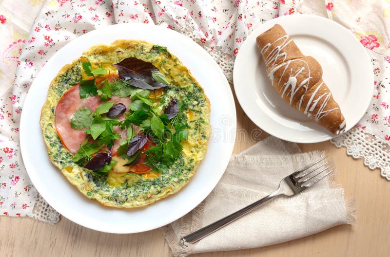 Breakfast with Omelet, Ham, Basil and Croissant. Stock Photo Image of