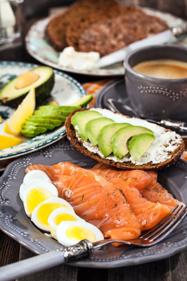 Breakfast with Salmon, Eggs, Avocado, Bread, Cheese and Coffee Stock