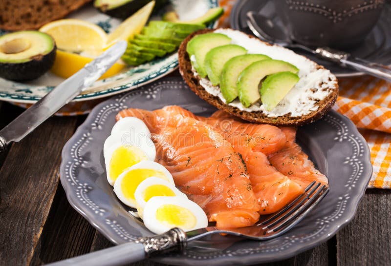 Breakfast with Salmon, Eggs, Avocado, Bread, Cheese and Coffee Stock