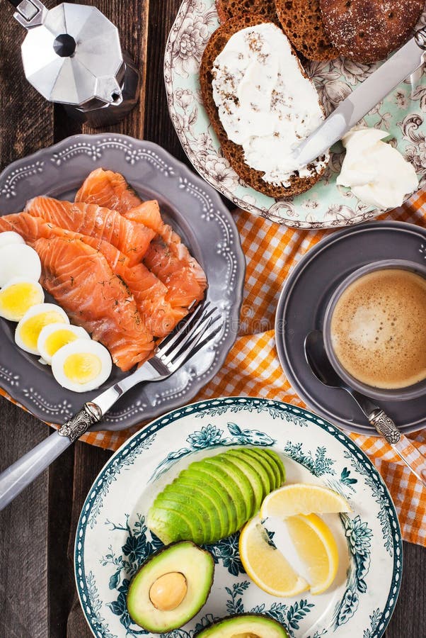 Breakfast with Salmon, Eggs, Avocado, Bread, Cheese and Coffee Stock