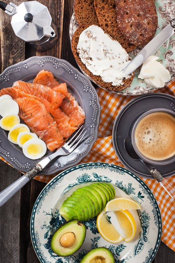 Breakfast with Salmon, Eggs, Avocado, Bread, Cheese and Coffee Stock