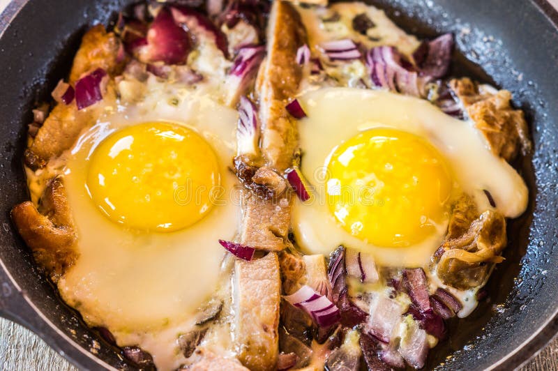 Breakfast with Scrambled Eggs with Bacon and Onions. Stock Image