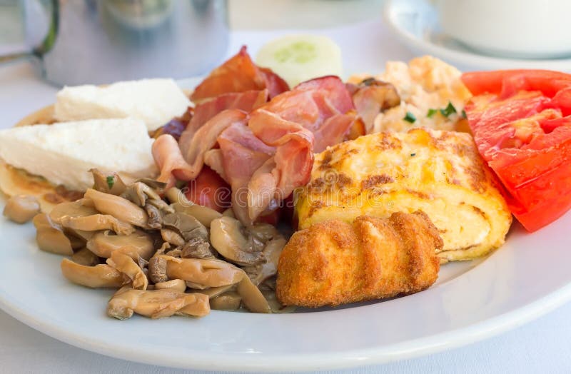 Breakfast : Scrambled Eggs, Ham , Mushrooms and Vegetables. Stock Photo