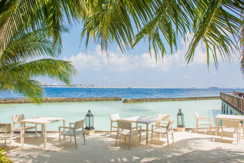 Breakfast setup with tables and chairs at the tropical beach stock photos Breakfast setup with tables and chairs at the tropical beach stock photos