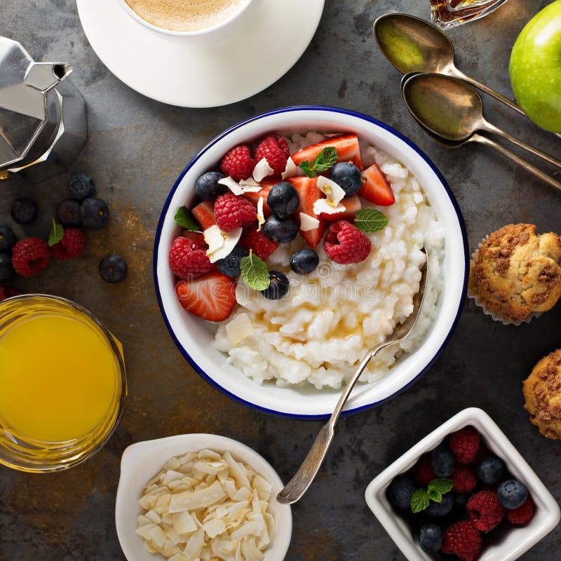 Breakfast table with rice pudding, fruit and muffins