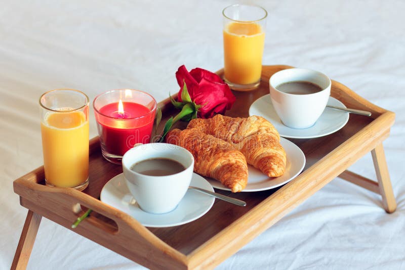 Breakfast table in bedwith orange juice, croissant and coffee royalty free ...