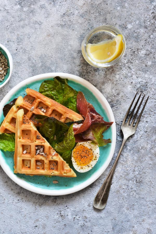 Breakfast Time. Waffle with Prosciutto, Salad and Egg for Breakfast on