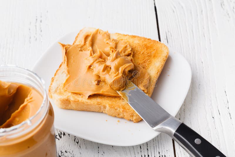 Breakfast with Toasted Bread and Peanut Butter on Table Stock Image