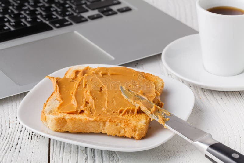 Breakfast with Toasted Bread and Peanut Butter on Table Stock Image
