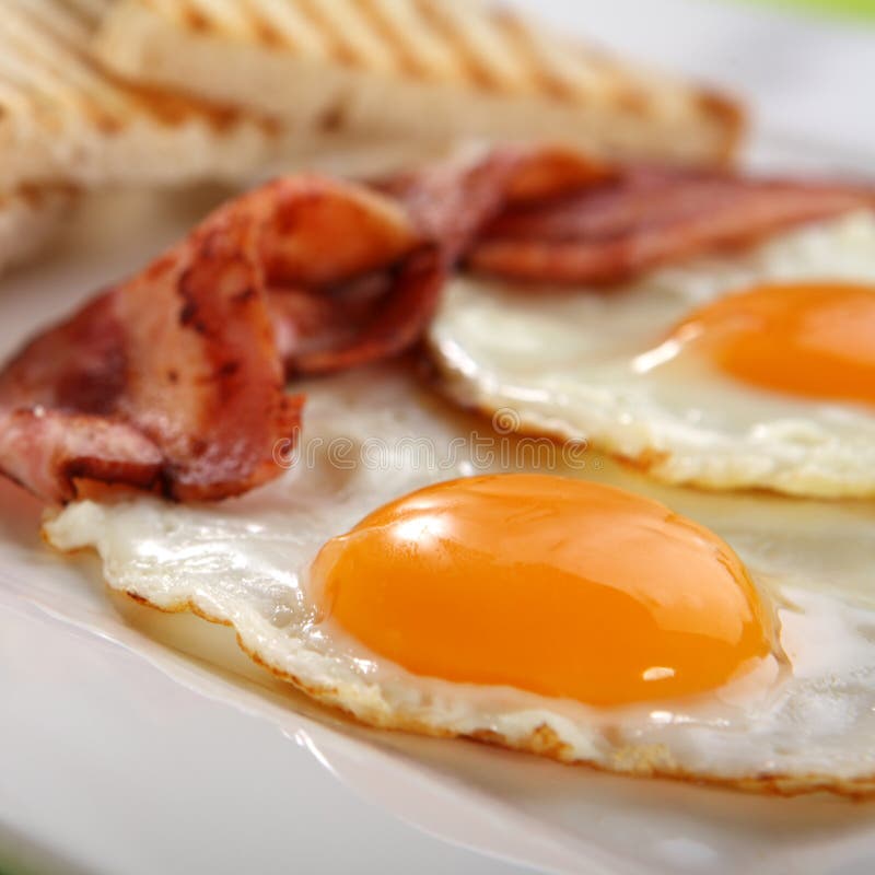 Breakfast - toasts, eggs, bacon royalty free stock image