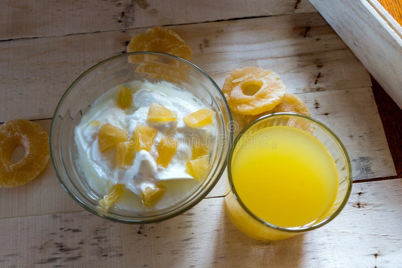 Breakfast with Yogurt with Pieces of Pineapple and Orange Juice Stock