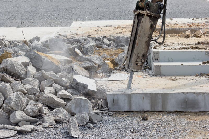 Breaking concrete with machine drilling or pneumatic hammer stock image